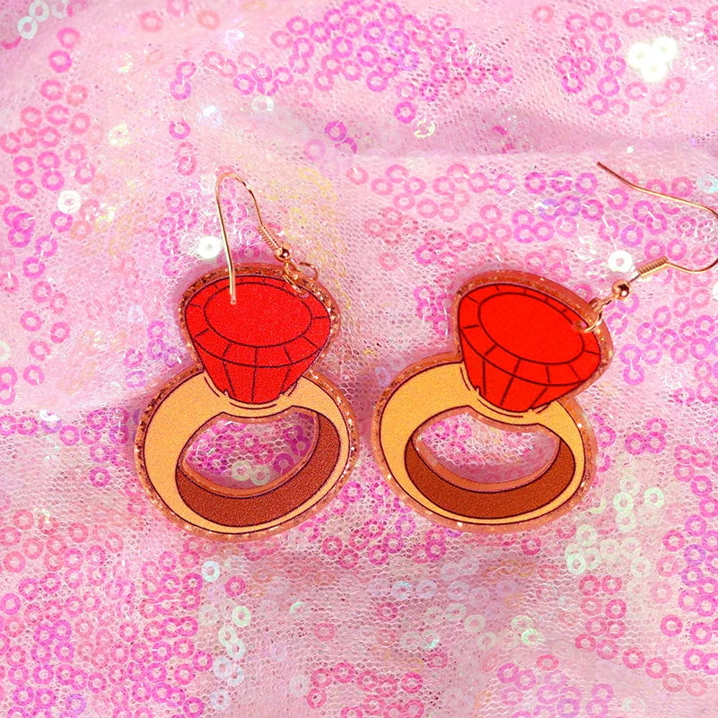 A pair of vibrant red and gold glittery y2k earrings featuring a cute flame snake design from the lightning queen alien set