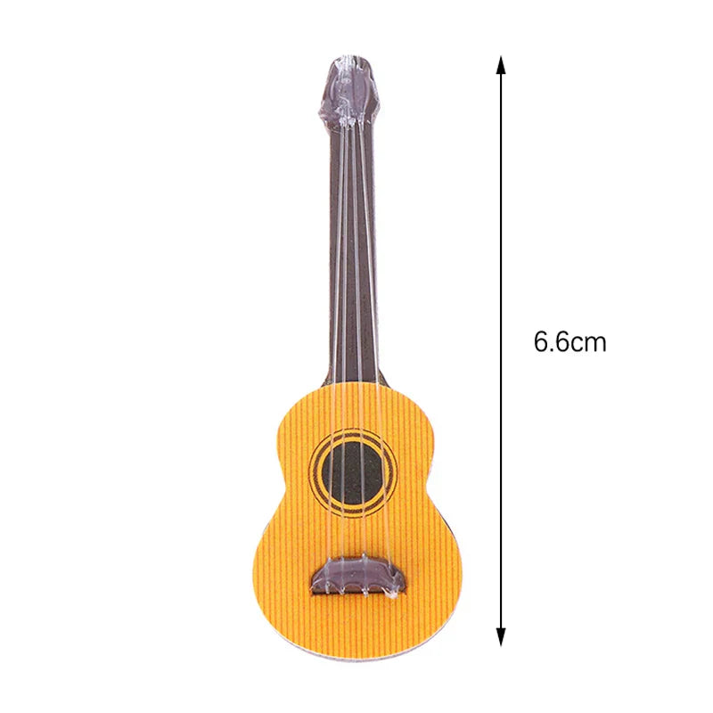 A miniature yellow acoustic guitar with striped wood grain and black strings for dollhouse miniature furniture playset