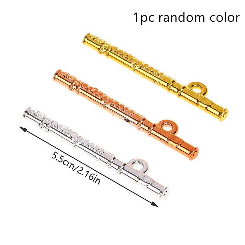 Three miniature flute-shaped charms in gold rose gold and silver finishes for 1:12 dollhouse miniature furniture playset