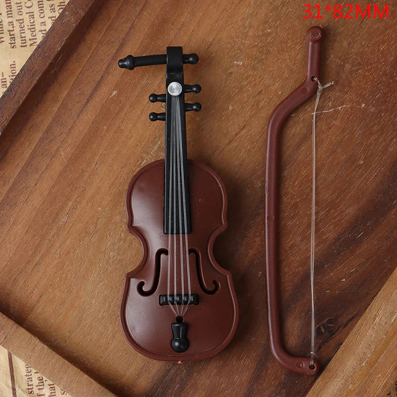 Brown plastic miniature violin with black hardware and bow in 1 12 dollhouse miniature furniture playset model living room