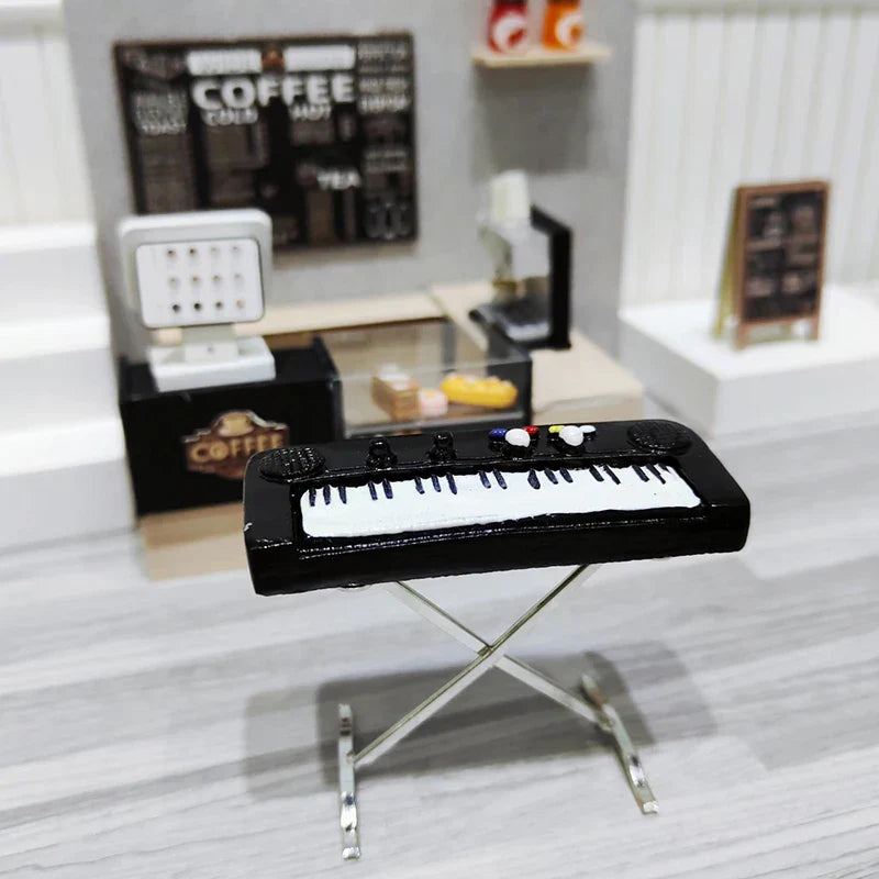 Black miniature keyboard with white keys and colorful knobs on a silver stand from dollhouse miniature furniture playset