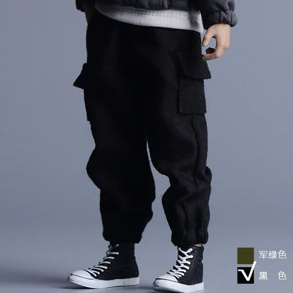 Black cargo pants with multiple pockets half zipper and relaxed tapered fit for male hip hop casual style