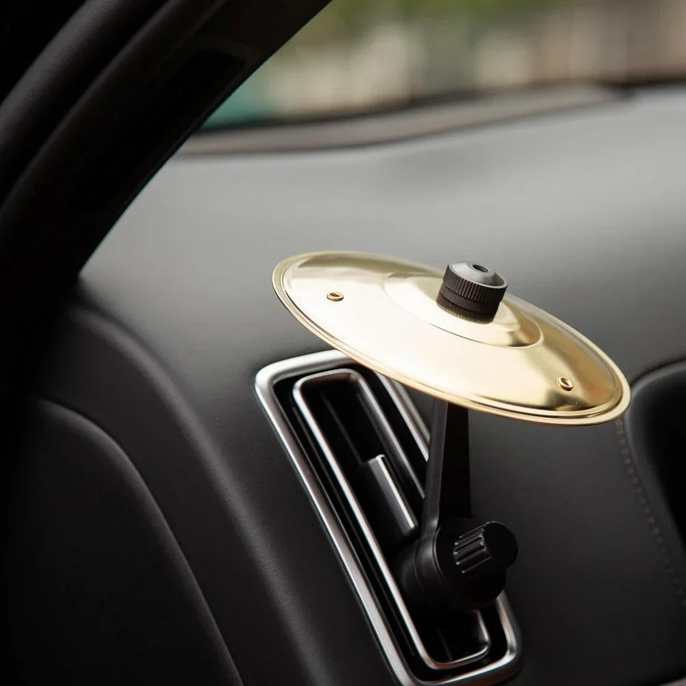 Gold-colored brass car crash cymbal air vent with black clamps and adjustment knobs for car interior use
