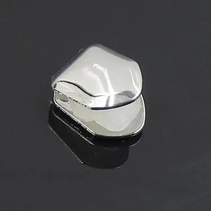 Shiny silver metal grill with a smooth polished surface and rounded edges single tooth caps for hip hop grills