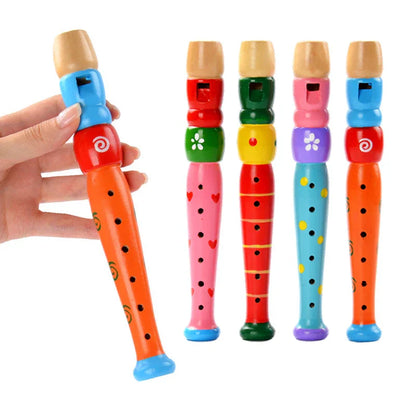 A wooden colorful piccolo flute with light brown mouthpiece painted orange black dots and green swirls for kids learning rhythm