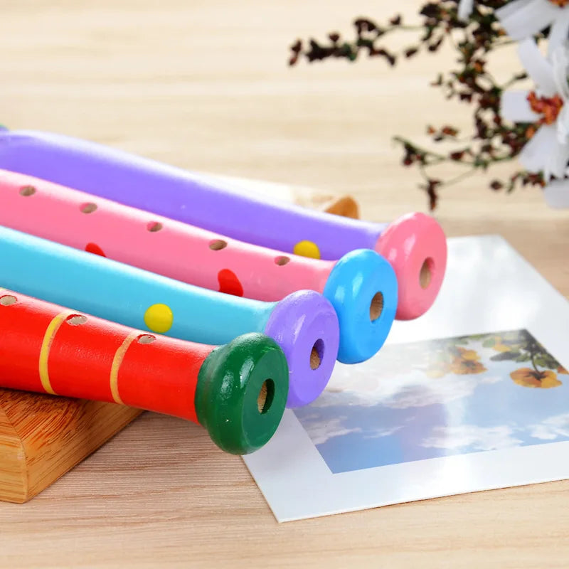 Colorful wooden piccolo flute with painted holes and decorative dots for kids learning rhythm and early music education