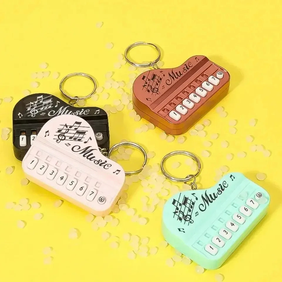 Heart-shaped piano keychain pendant with luminous mini electronic piano design in black white copper and mint green plastic