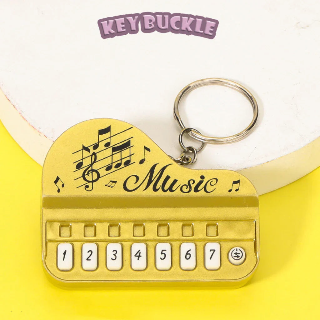 Gold-colored piano keychain pendant with music engraving mini electronic piano luminous music toy gift