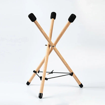 Light-colored solid wood triangle drum stand with black rubber tips for percussion instrument adjustable use