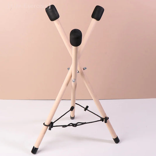 Light-colored solid wood triangle drum stand with black rubber caps and cross-braced design for percussion instrument adjustable use