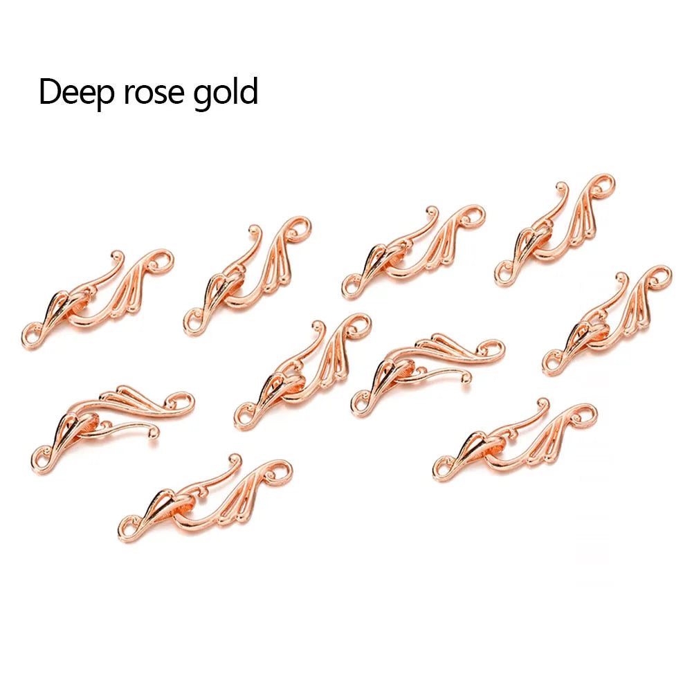 Deep rose gold ornate metal clasps with flowing curves for jewelry making in antique bronze silver musical note hook style