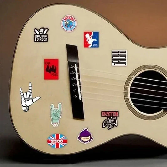 Acoustic guitar with light wood finish decorated with colorful 100pcs classic graffiti music band decals for diy guitar
