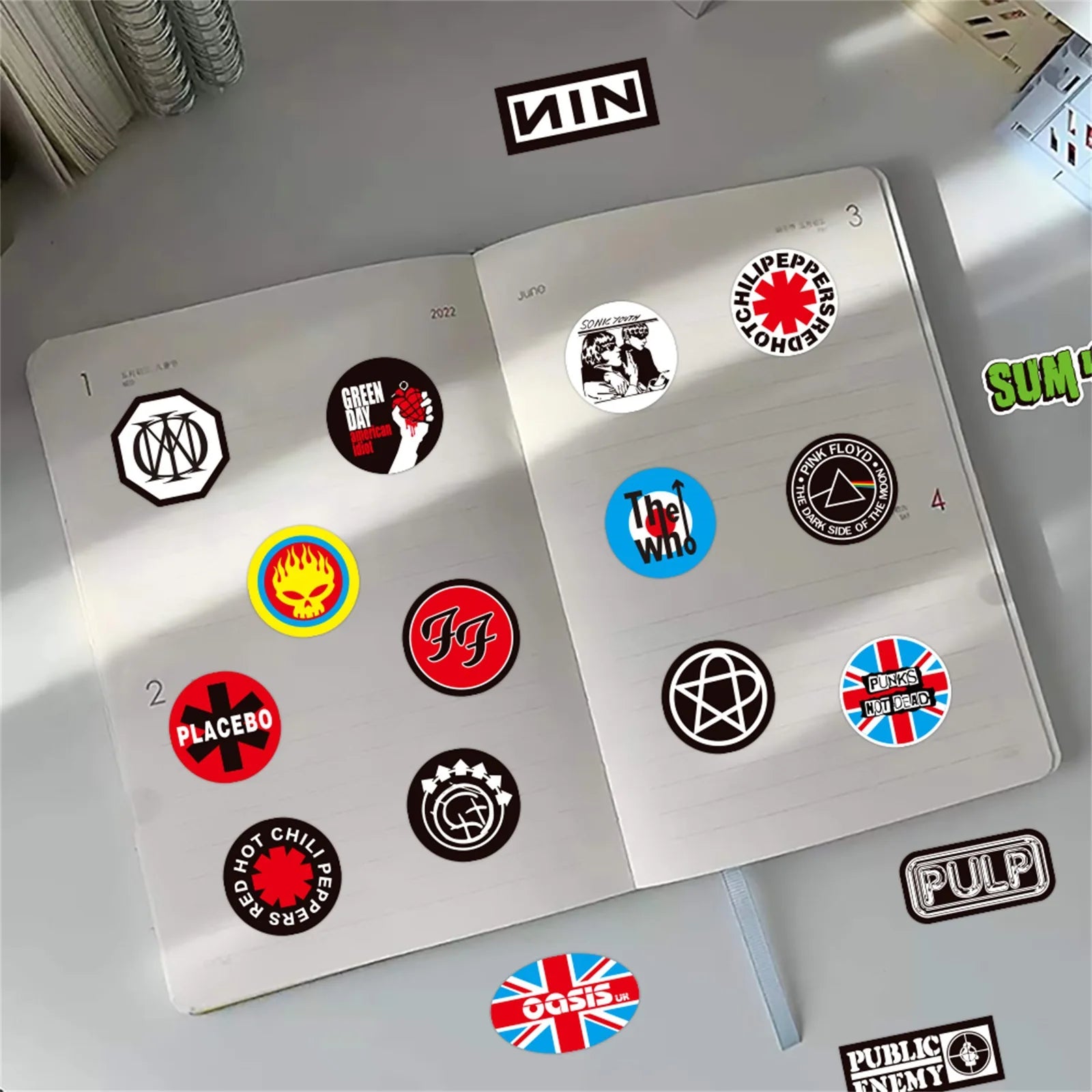 A silver notebook open to colorful punk style stickers featuring personalized decorative graffiti for toys diy scrapbook use
