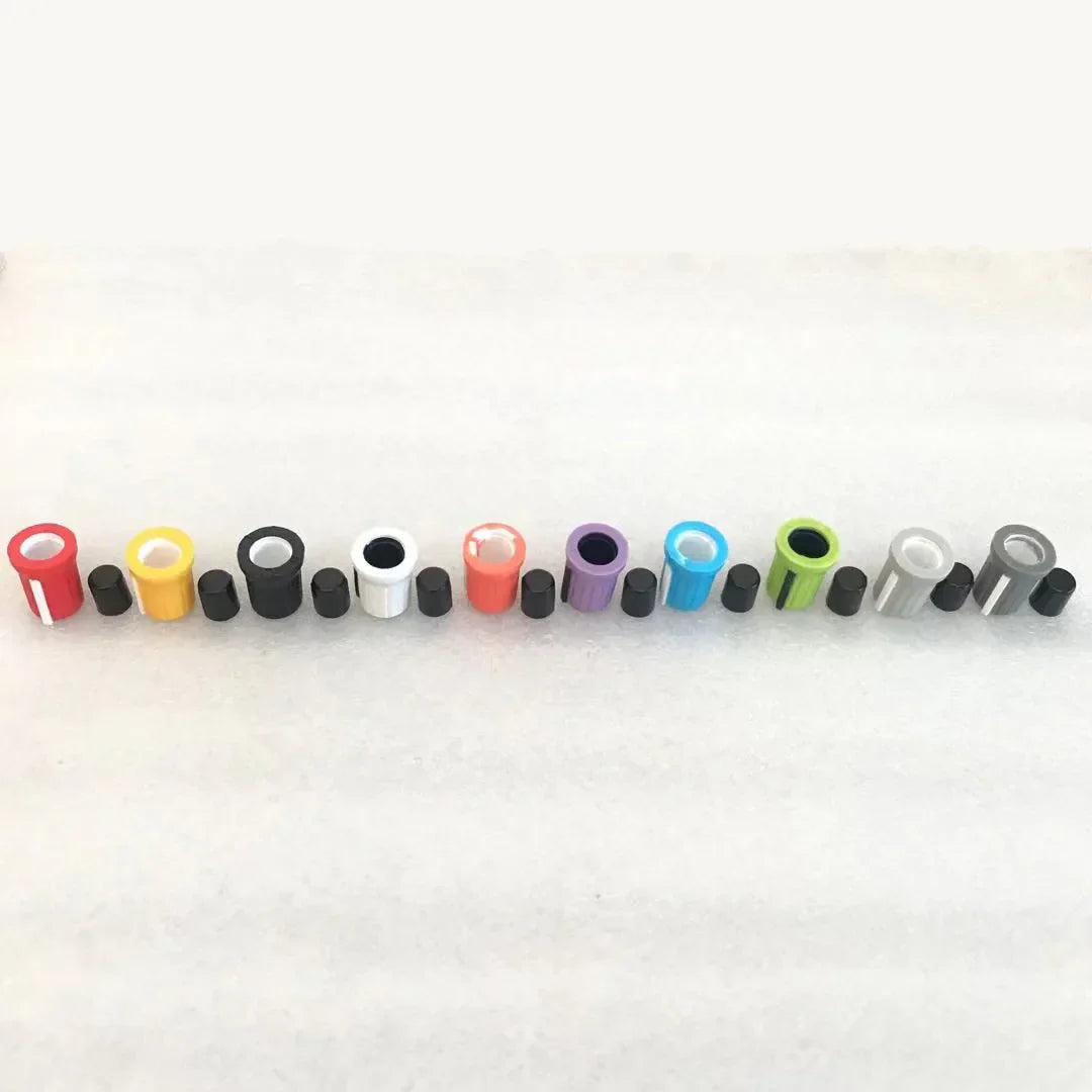 A row of colorful plastic and metal high and low eq gain knob caps for pioneer djm750 mixer ddj-sb and aero djm-t1 controllers