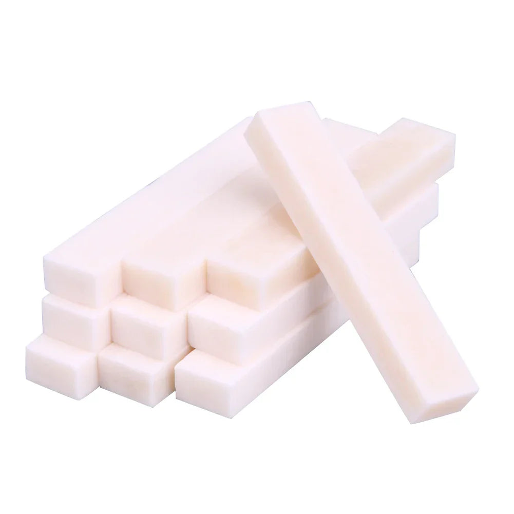Stack of off-white guitar blank bone rectangular foam blocks for professional buffalo bone guitar nut replacement parts