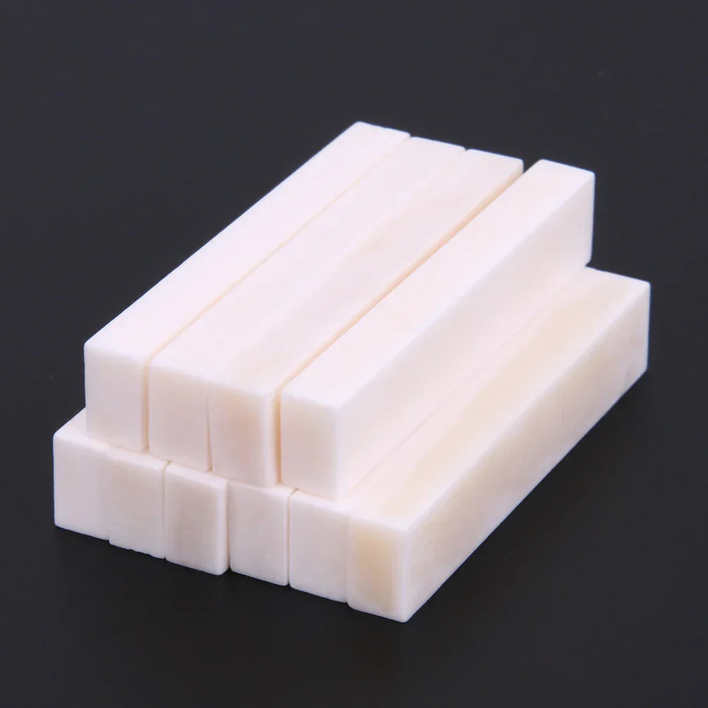 White rectangular guitar blank bone nuts stacked neatly made of buffalo bone for professional guitar replacement parts