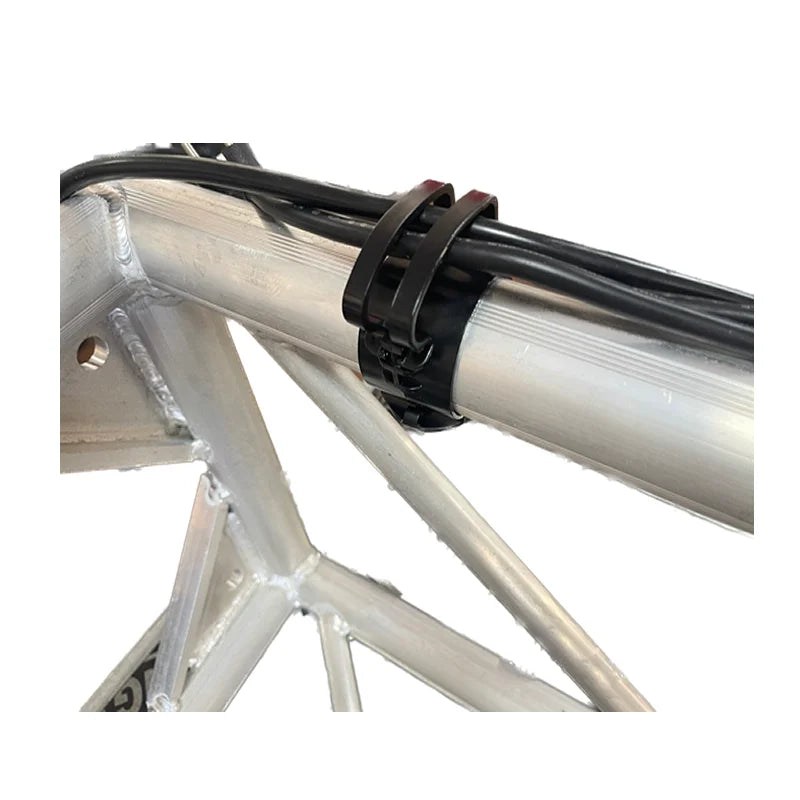 Black plastic lighting wire clip securing black wires to silver truss aluminum frame for card audio line management