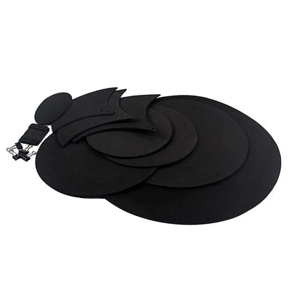 Black circular drum mute pads with matte finish and varying sizes made of sponge for drumming practice and noise reduction