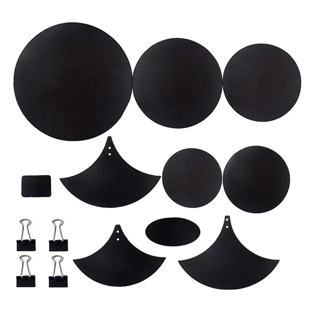 Set of black circular and crescent-shaped drum mute pads made of sponge with matching binder clips for drumming practice
