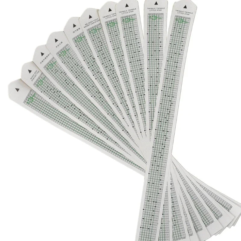 White paper tape with green grid lines and black dots labeled twinkle twinkle little star for 15note diy hand crank music box