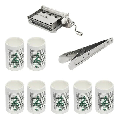Set of eight white cylindrical paper tape rolls with green music notes and silver hand crank music box mechanism for 15note diy hand