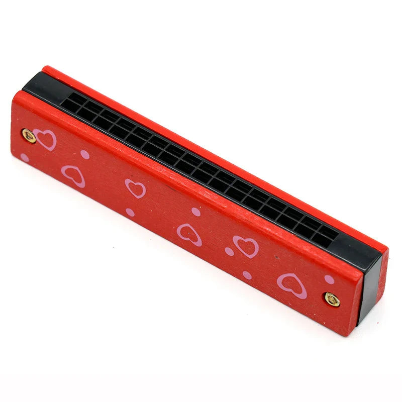 Red 16-hole wooden harmonica with pink heart and dot decals featuring black mouthpiece for kids early educational play