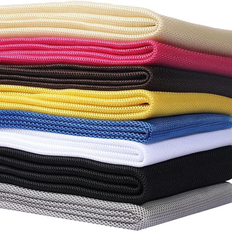 Stack of colorful 160x200cm speaker mesh cloth sheets in cream pink black yellow blue white and gray for dustproof use