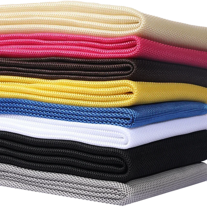 Stack of colorful 160x200cm speaker mesh cloth sheets in cream pink black yellow blue white and gray for dustproof use