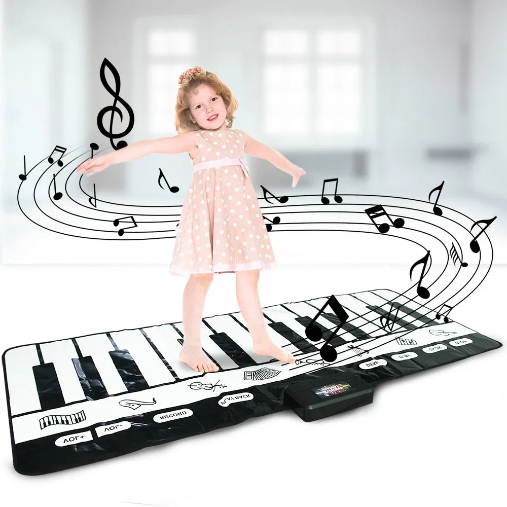 A child stands barefoot on a black and white inflatable play piano keyboard instrument game carpet for children musical toys