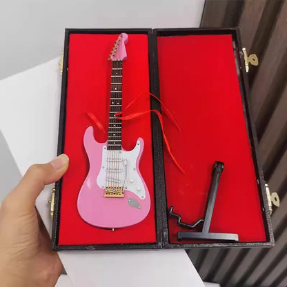Pink mini electric guitar with white pickguard and gold hardware in black velvet case wooden musical instruments model with support
