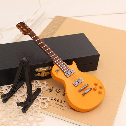 Orange mini electric guitar wooden musical instruments model with glossy finish and detailed hardware on support miniature model