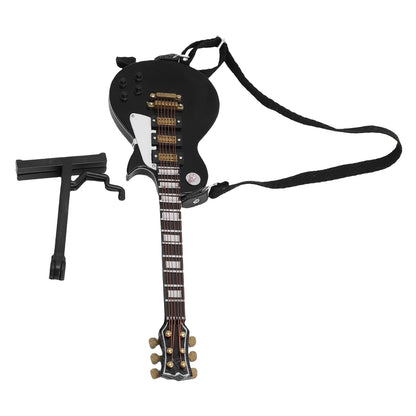 Black miniature electric guitar with gold hardware and white pickguard displayed on a wooden case for home desk shelves decoration