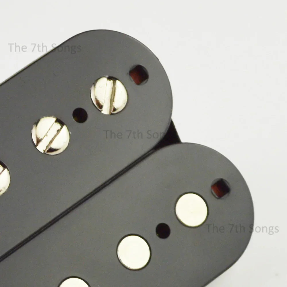 Black humbucker guitar pickups with shiny silver screws and white pole pieces featuring paf g alnico vintage tone and braided leadd