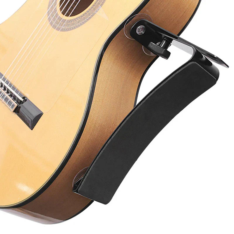 Black plastic guitar strap clip with ergonomic design for secure attachment on classical guitar backrest frame