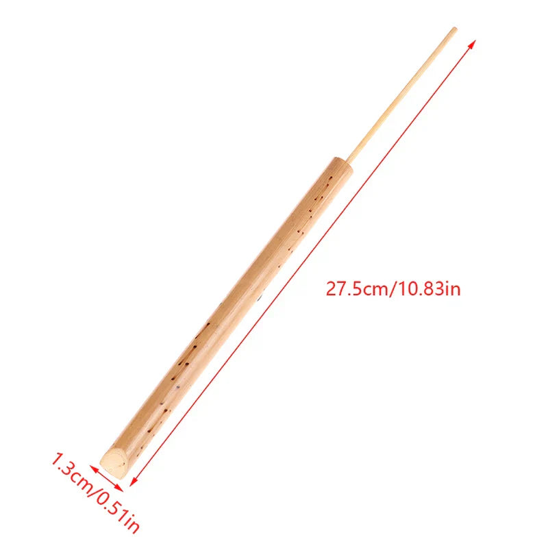 A light brown bamboo musical instrument flute with slender cylindrical body and finger holes used as bird whistle toy