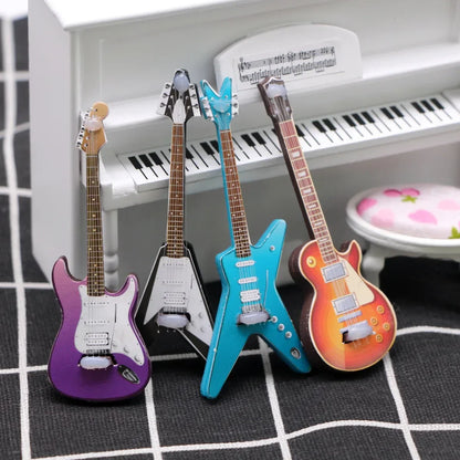 Four vibrant miniature electric guitars in purple black turquoise and orange on checkered surface for dollhouse mini christmas wood grain decor