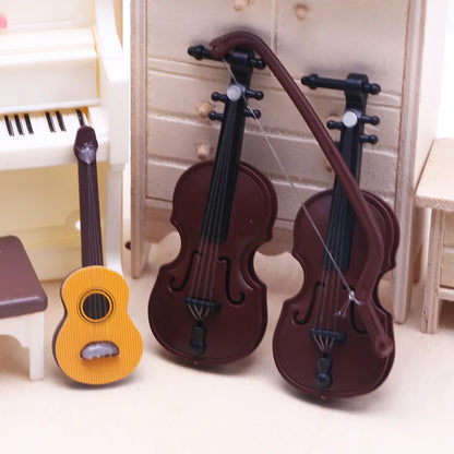 Two miniature brown wood grain violins and a yellow acoustic guitar in a dollhouse mini christmas scene model decor