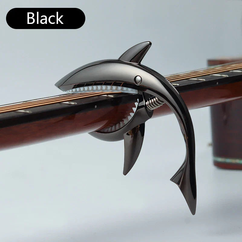 Black metal shark capo with metallic finish and detailed teeth for electric guitar tone variation and clip bass bridge use