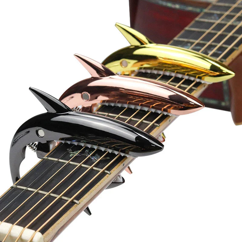 Metal shark capo in black rose gold and yellow zinc alloy finishes for electric guitar tone and clip bass bridge use
