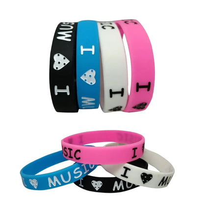 A set of colorful music silicone wristbands in black blue white and pink featuring love music silicone fans silicone rubber design