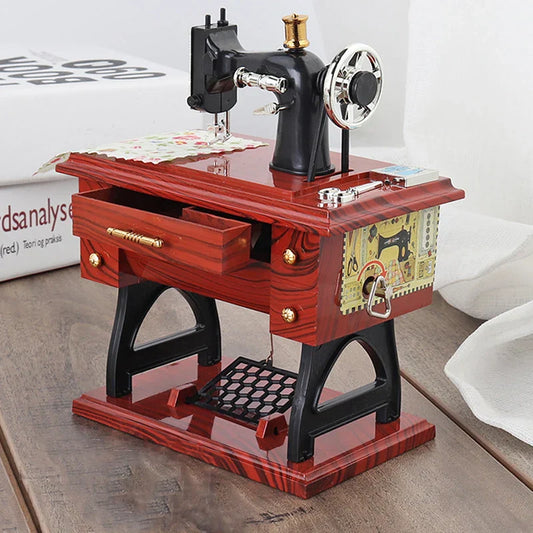 Red wooden desk with black and silver miniature sewing machine music box retro for clockwork home crafts decor