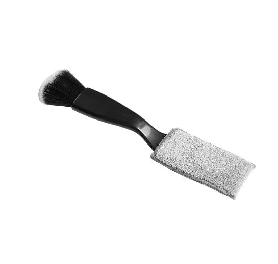Black-handled guitar care brush with soft black bristles and gray microfiber cloth for string fingerboard cleaning and dust removal