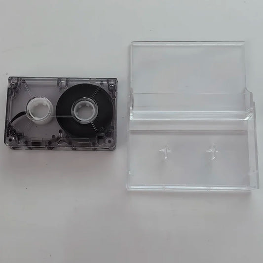 Clear plastic mini interview tape with black magnetic tape and silver spools in a transparent interview machine cassette case