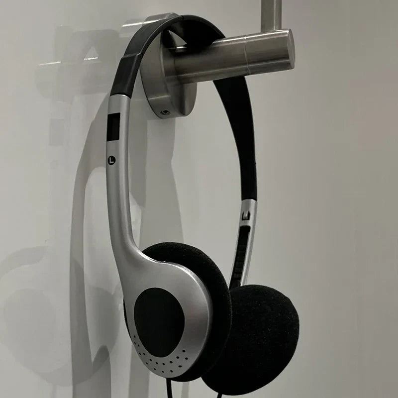 Silver and black wired small headphones with padded earcups and metallic frame for retro classic headset music mp3 walkman use