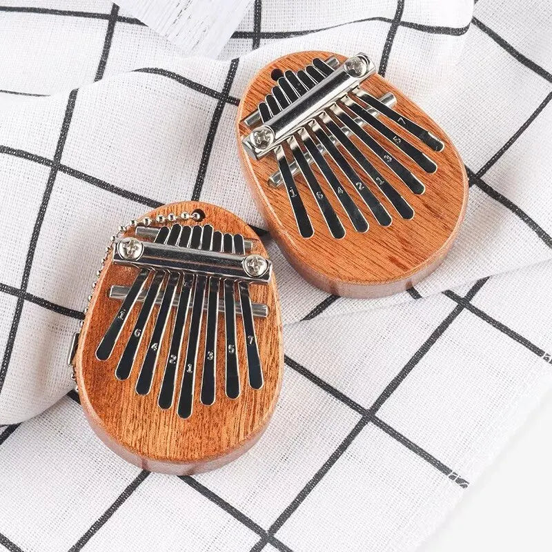 Two wooden thumb piano musical instruments with black metal keys and silver hardware 8 tones portable beginner finger piano
