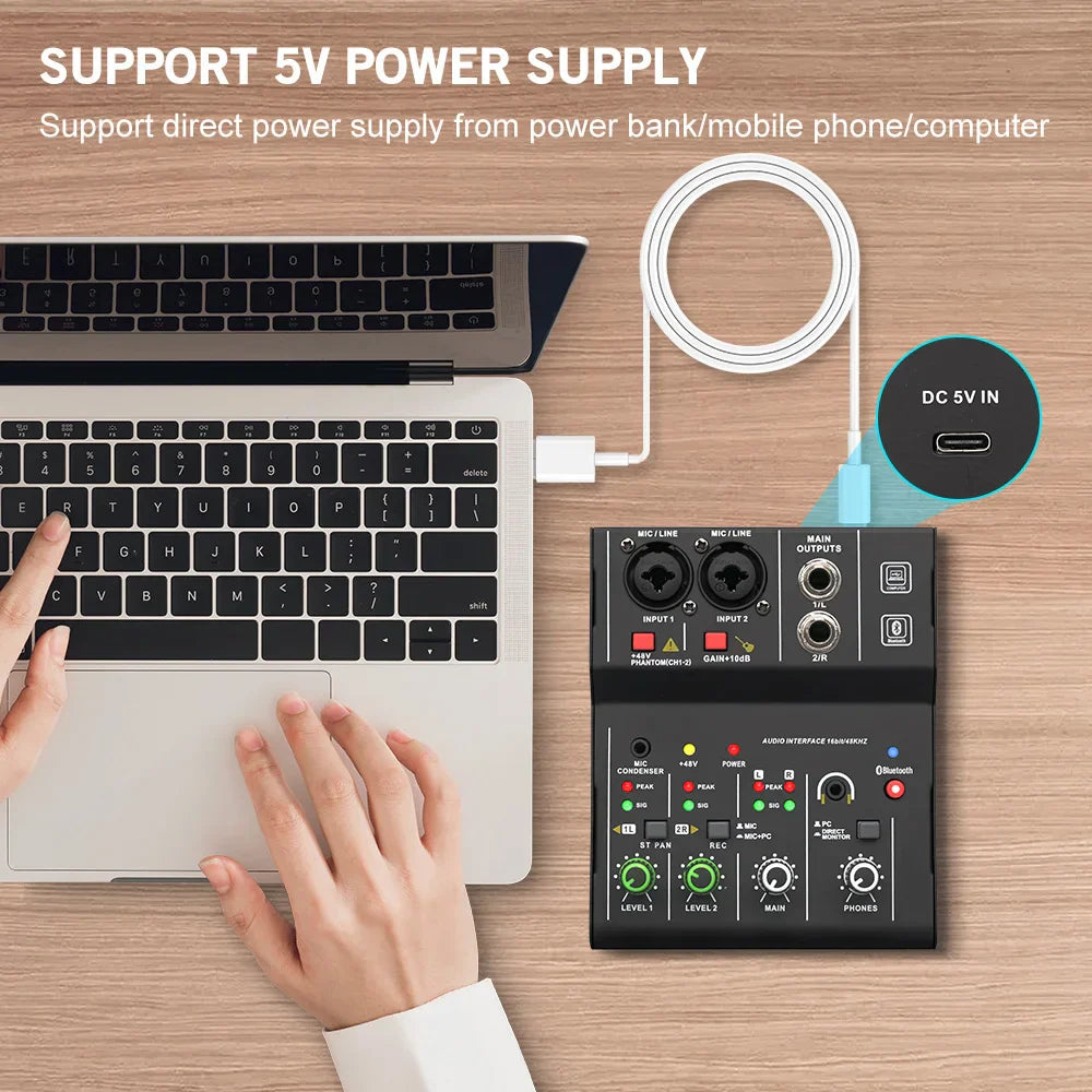 Black 2 channel professional portable audio interface sound card console connected to laptop for guitar studio singing