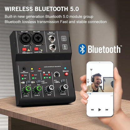Black portable audio interface with green knobs and labeled mic line in out headphone ports for guitar studio singing Q12-M