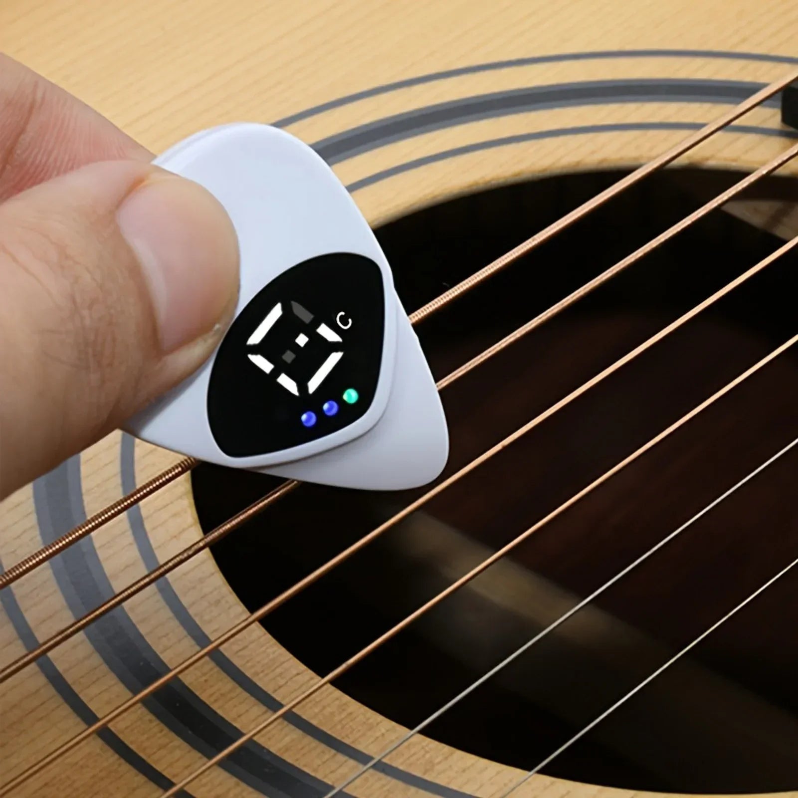 White 2-in-1 guitar pick with black digital display showing c and three lights multi-purpose pitch calibrator for 12-tone equal temperament