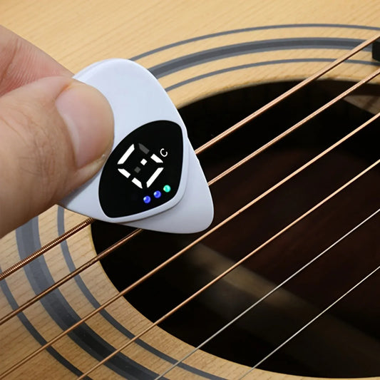 White 2-in-1 guitar pick with black digital display showing c and three lights multi-purpose pitch calibrator for 12-tone equal temperament