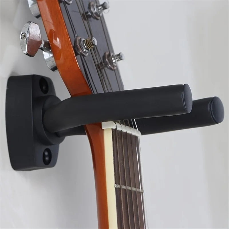 Black guitar wall mount holding orange acoustic guitar neck in sturdy 2-pack double guitar stand for electric guitars